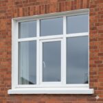 Brilliant white three-part uPVC tilt-and-turn window installed in traditional Dublin house facade — Dublin Blinds