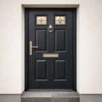 Black traditional composite door with decorative glass and rustic metalwork professionally installed in a Dublin home entrance — Dublin Blinds